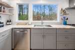 Large windows in kitchen surrounded by subway tile